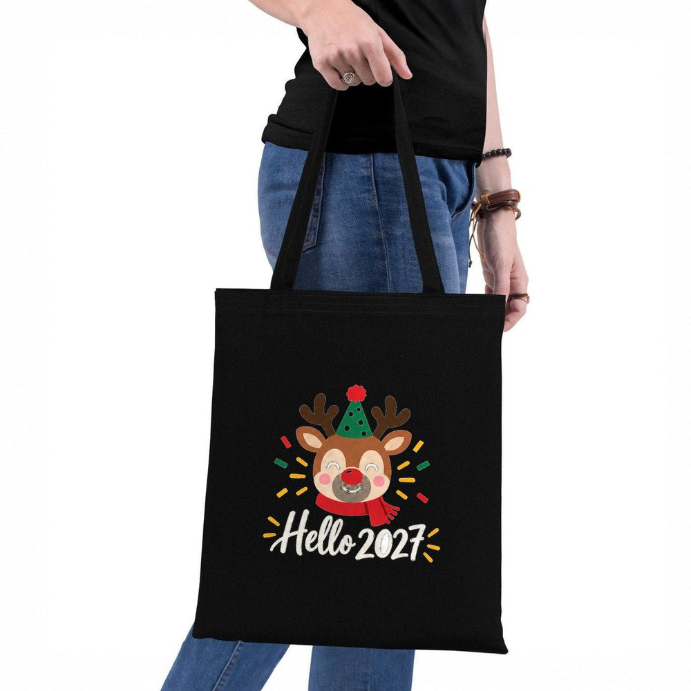 Shopper natalizie appese al muro: naturale con Buon Natale, rossa con Buon Anno 2027, nera con Fuori fa freddo
